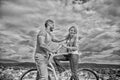 Man with beard and shy blonde lady on first date. How to meet girls while riding bike. Picking up girl. Couple just meet Royalty Free Stock Photo