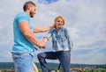 Man with beard and shy blonde lady on first date. How to meet girls while riding bike. Picking up girl. Woman feels shy Royalty Free Stock Photo