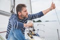 Man with beard sits on deck of sailing yacht Royalty Free Stock Photo