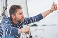 Man with beard sits on deck of sailing yacht Royalty Free Stock Photo