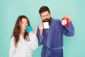 Man with beard and sleepy woman enjoy morning coffee or tea. Time to wake up and have nice day. Guy husband hold coffee Royalty Free Stock Photo