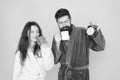 Man with beard and sleepy woman enjoy morning coffee or tea. Time to wake up and have nice day. Guy husband hold coffee Royalty Free Stock Photo