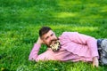 Man with beard on smiling face enjoy nature. Masculinity concept. Hipster with daisies in beard looks attractive Royalty Free Stock Photo