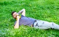 Man with beard on smiling face enjoy spring. Carefreeness concept. Bearded man with dandelion flowers in beard lay on Royalty Free Stock Photo