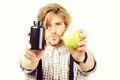 Man with beard and stylish hairdo holds apple and pills Royalty Free Stock Photo