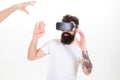 Man with beard and tattoo making protective gesture against male contestant in virtual reality computer game, gaming Royalty Free Stock Photo