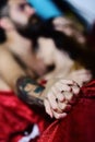 Man with beard and tattoos holds female hand, selective focus Royalty Free Stock Photo