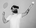 Man with beard in VR glasses, grey background. Hipster on concentrated face use modern technology for sport games