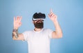 Man with beard in VR glasses, light blue background. Hipster on busy face exploring virtual reality with gadget. Guy Royalty Free Stock Photo