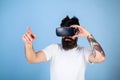 Man with beard in VR glasses, light blue background. Interactive surface concept. Hipster on busy face exploring virtual Royalty Free Stock Photo