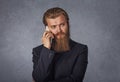 Man with beard walking and talking with mobile phone isolated grey background wall Royalty Free Stock Photo