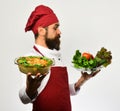 Man with beard, white background. Chef hold bowl with potato