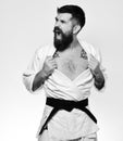 Man with beard in white kimono on white background.