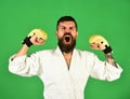 Man with beard in white kimono on green background