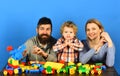 Man with beard, woman and boy play on blue background.