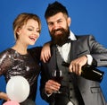 Man with beard and woman in dress on blue background