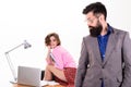 Man bearded boss stand in front of sexy girl working laptop. Office manager or secretary. Sexy lady worker. Sexy Royalty Free Stock Photo