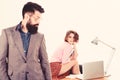 Man bearded boss stand in front of sexy girl working laptop. Office manager or secretary. Sexy lady worker. Sexy Royalty Free Stock Photo