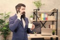 Man bearded businessman hold cup and smartphone. Coffee is pledge of successful negotiations. Caffeine addicted. Mobile