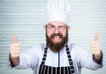 Man bearded chef getting ready cooking delicious dish. Chef at work starting shift. Guy in professional uniform ready Royalty Free Stock Photo