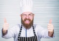 Man bearded chef getting ready cooking delicious dish. Chef at work starting shift. Guy in professional uniform ready Royalty Free Stock Photo