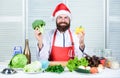 Man bearded chef wear santa claus hat cooking. How to enjoy holiday meals. Christmas diet. Enjoy healthy christmas