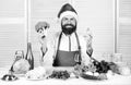 Man bearded chef wear santa claus hat cooking. How to enjoy holiday meals. Christmas diet. Enjoy healthy christmas
