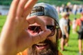 Man bearded in front of crowd riverside background. Be sure in your summer vacation. Book ticket summer festival in