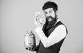 Man bearded guy hold jar full of cash savings. Safe place to keep money. Personal accountant. Businessman with his Royalty Free Stock Photo