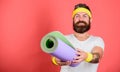 Man bearded happy athlete hold mat red background. Athlete coach ready for training. Old school aerobics concept