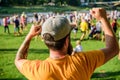 Man bearded hipster in front of crowd. Open air concert. Book ticket now. Early bird sale. Music festival. Entertainment