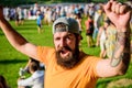 Man bearded hipster in front of crowd. Open air concert. Fan zone. Music festival. Entertainment concept. Visit summer Royalty Free Stock Photo