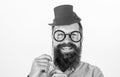 Man bearded hipster hold cardboard top hat and eyeglasses to look smarter white background. Dress affects how people see