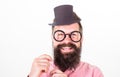 Man bearded hipster hold cardboard top hat and eyeglasses to look smarter white background. Dress affects how people see