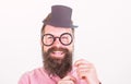 Man bearded hipster hold cardboard top hat and eyeglasses to look smarter white background. Dress affects how people see