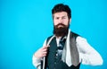 Man bearded hipster hold few neckties on blue background. Guy with beard choosing necktie. Gentlemens guide. How to