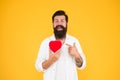 Man bearded hipster hold red heart. Prescribe medication lower blood pressure cholesterol. Feel pulse check heart rate