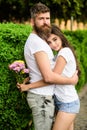 Man bearded hipster hugs woman. Man fall in love with gorgeous girl. Strong romantic feelings become true love. Couple