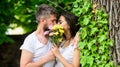 Man bearded hipster kisses girlfriend. Secret romantic kiss. Moment of intimacy. Couple in love hiding behind bouquet Royalty Free Stock Photo