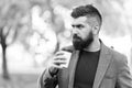 Man bearded hipster prefer coffee take away. Businessman drink coffee outdoors. Reloading energy. Relaxing coffee break Royalty Free Stock Photo