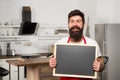 Man bearded hipster red apron stand in kitchen. Kitchen furniture store. Kitchen hacks concept. Clever ways to organize