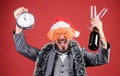 Man bearded hipster santa hold bottle. Corporate christmas party. Lets celebrate winter holiday. Boss santa hat