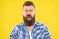 Man bearded hipster with sneezing face closed eyes close up yellow background. Brutal hipster sneezing. Allergy concept Royalty Free Stock Photo