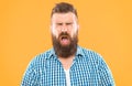 Man bearded hipster with sneezing face closed eyes close up yellow background. Brutal hipster sneezing. Allergy concept Royalty Free Stock Photo