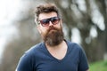 Man bearded hipster wear sunglasses nature background. Masculinity concept. Macho with beard and mustache look confident Royalty Free Stock Photo