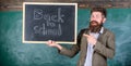 Man bearded holds blackboard inscription back to school. Back to school teachers recruitment. Looking committed teacher