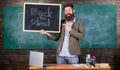 Man bearded holds blackboard inscription back to school. Hiring teachers for new school year. Looking committed teacher