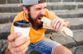 Man bearded shows paper cup drink stairs background. Energy from street food daily traditional snack. Take coffee with