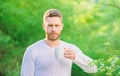 Man bearded tea farmer hold mug nature background. Green tea contains bioactive compounds that improve health. Whole