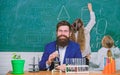 Man bearded teacher work with microscope and test tubes in biology classroom. Biology plays role in understanding of